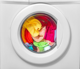 Washing machine with laundry loaded for washing.